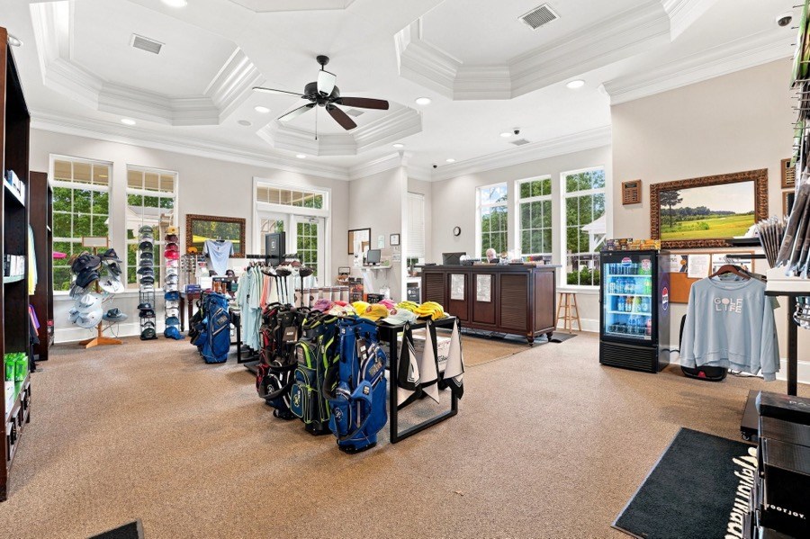 Belmont Lake Golf Club pro shop with golf bags on display, a checkout counter, and beverage cooler