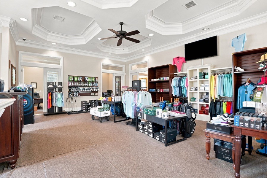 Golf shop interior with checkout counter, apparel racks, and FootJoy shoe displays